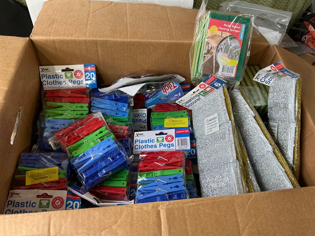 Carton of Plastic Clothes Pegs and Sponges