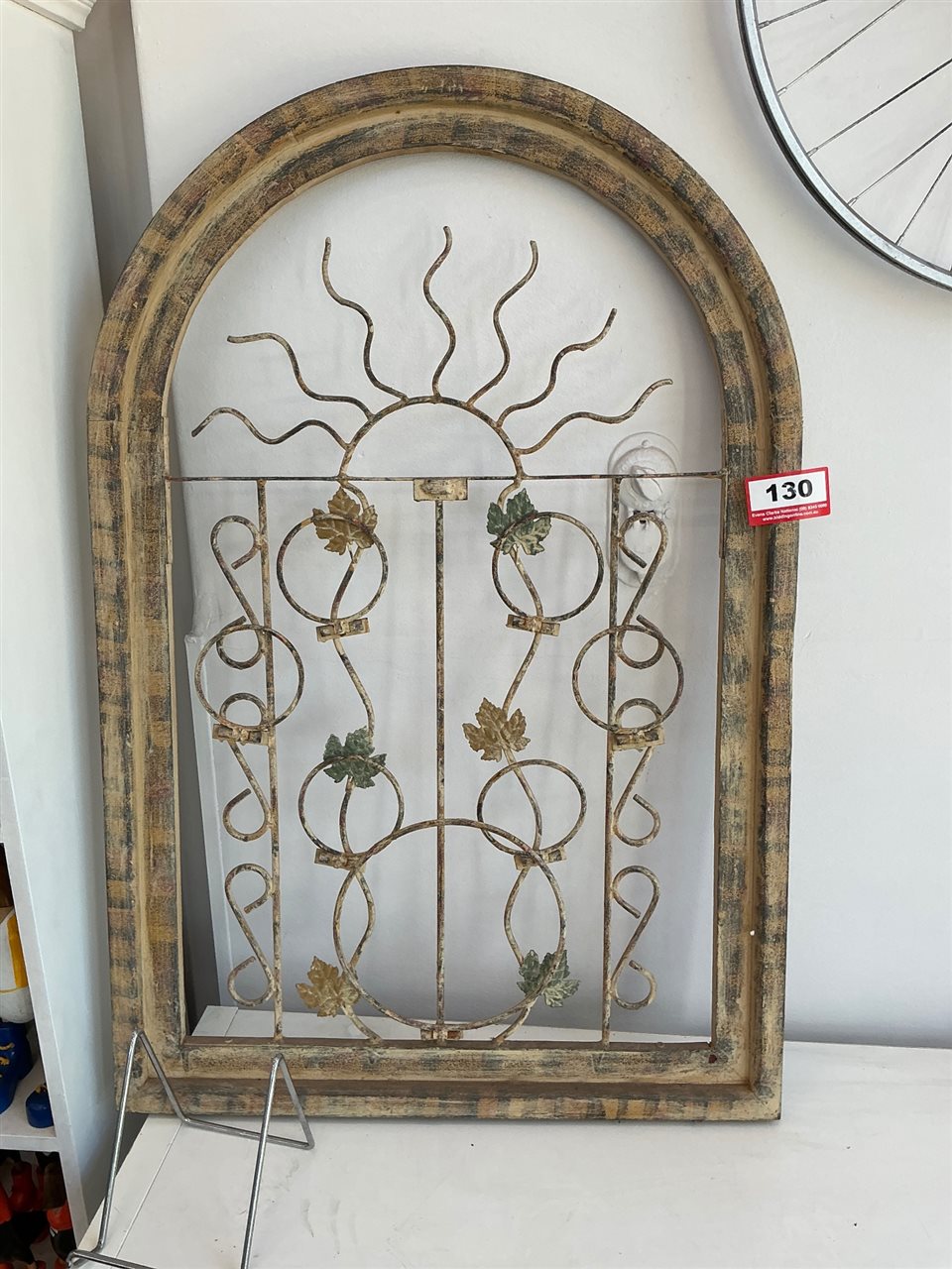 Arched Timber Frame with Wrought Iron Sun and Vine Grille